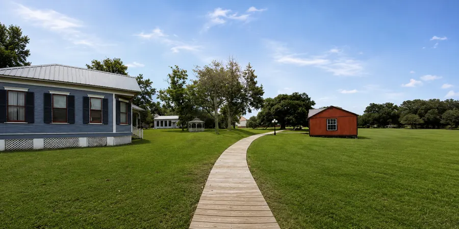 Boardwalk across the lawns between the historic cottages