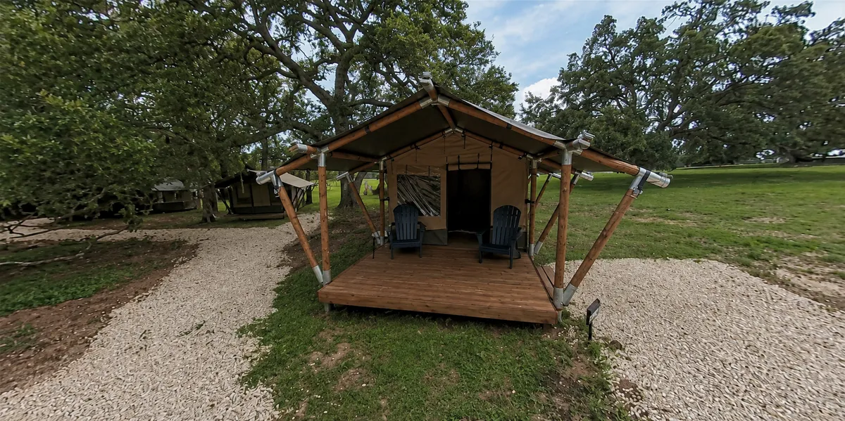 A safari glamping tent with a timber porch
